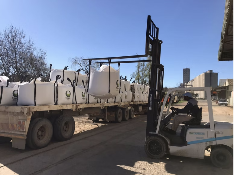 Forklift loading bulk bags onto trailers at the depot